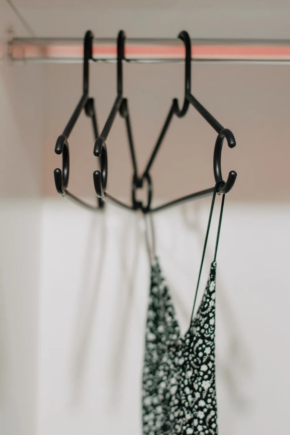 Clothes hanging neatly inside a wardrobe