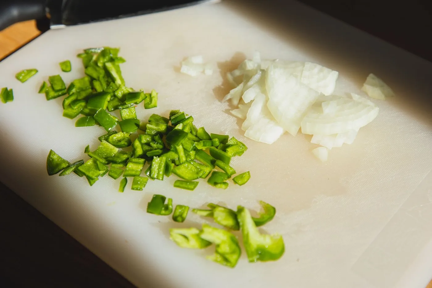 Fresh vegetables prepared on a kitchen cutting board
