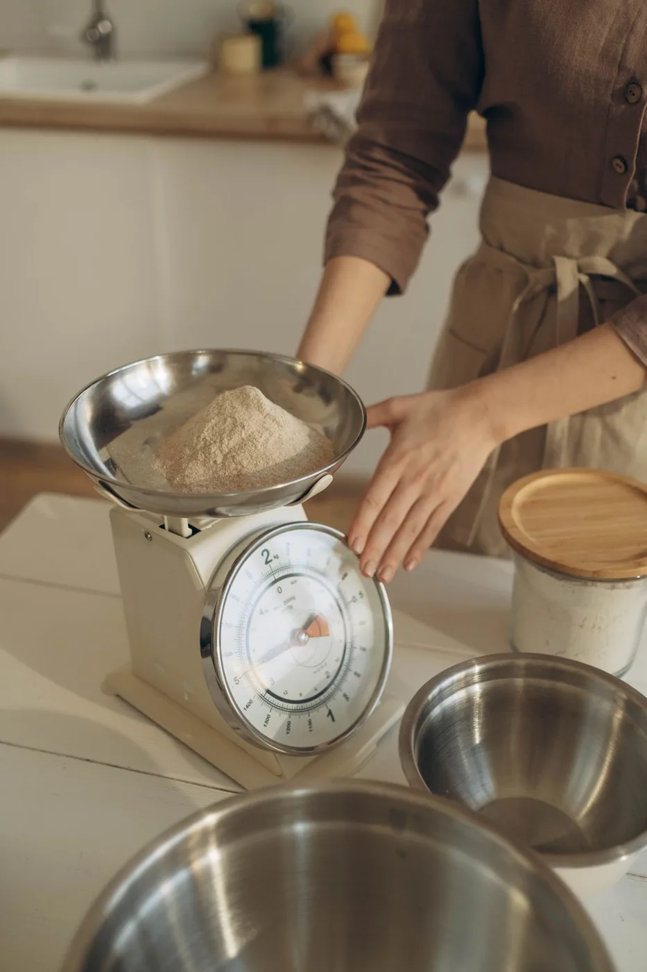 Flour being weighed on a kitchen scale for baking