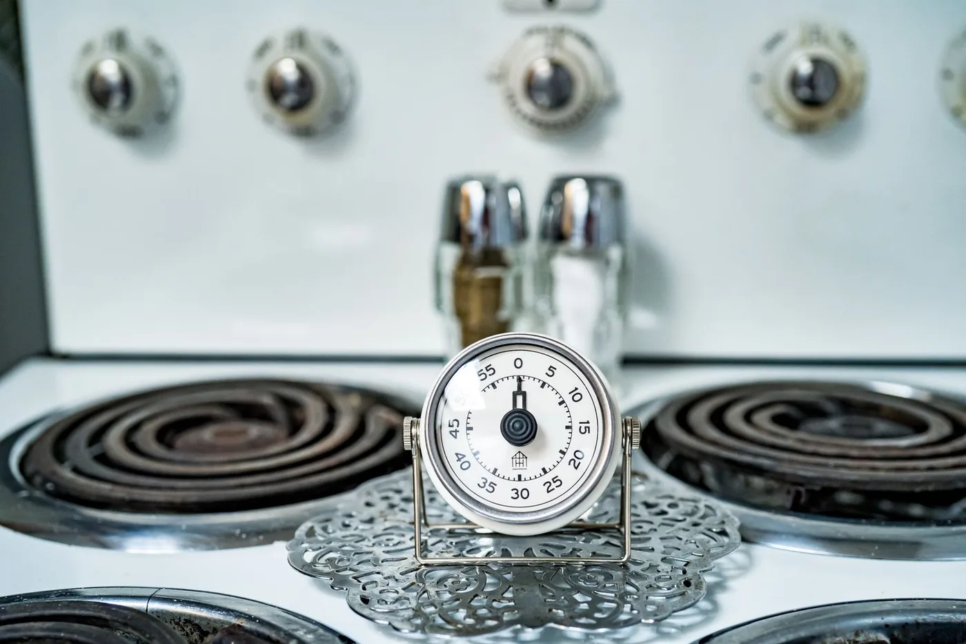An analog kitchen timer on a stove
